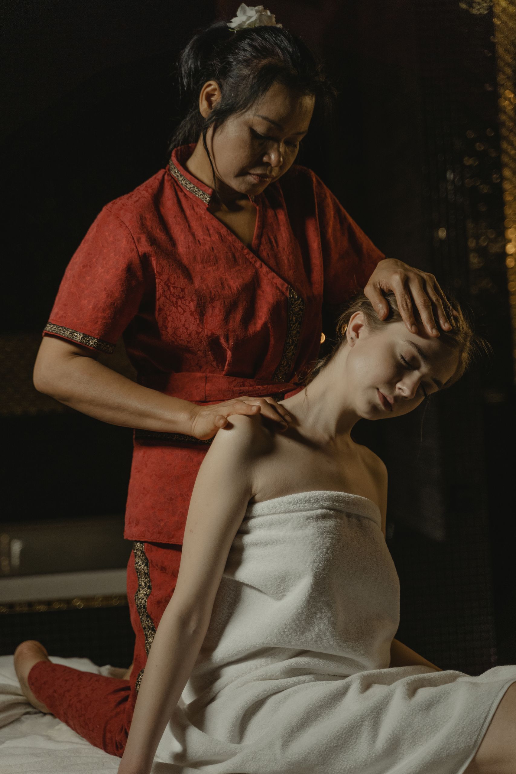 A soothing massage therapy session focusing on relaxation and wellbeing in a dimly lit spa.
